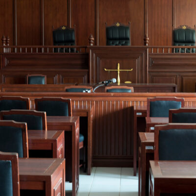 A table and chair in the courtroom of the judiciary.