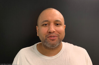 Mikal Mahdi headshot wearing a white tee shirt.
