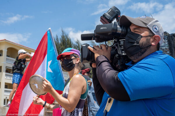 A individual filming a protest in Rincon, Puerto Rico.
