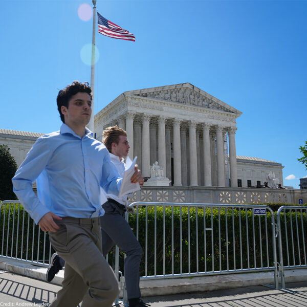 Washington DC USA - July 1, 2024 - Reporters run paper copies of the Supreme Court decision to network anchors and analysts for live TV reports.