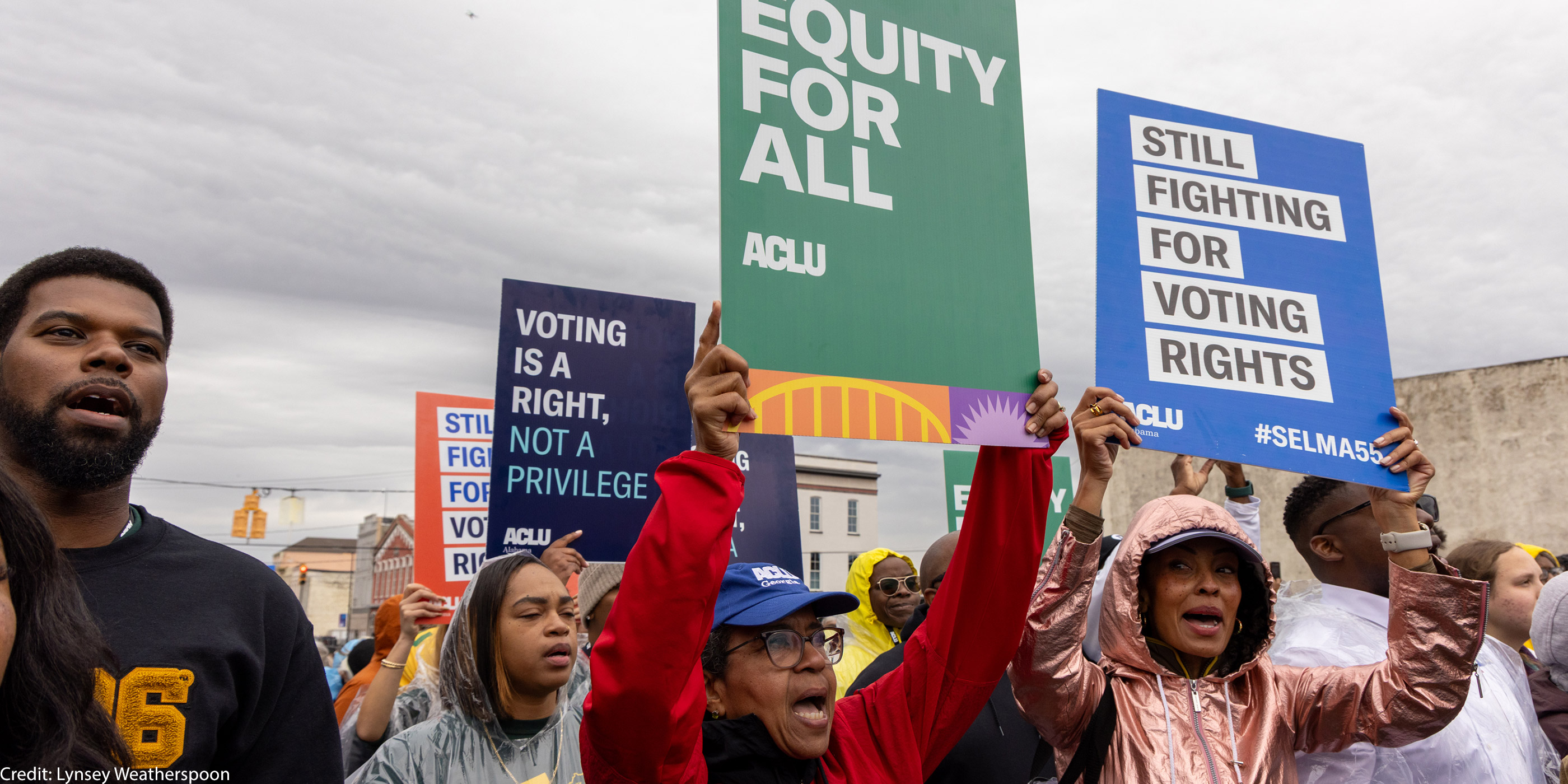 A group of voting rights advocates marching over the Edmund Pettus Bridge.