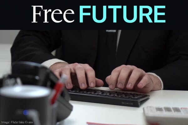 Closeup of a person's hands typing on a computer keyboard