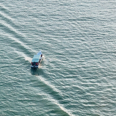 High-angle aerial shot of a small motorboat.